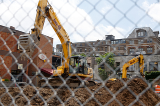 Construction workers excavate the ground on the former site of some popular Syracuse University student hangouts. Photo taken July 18, 2017
